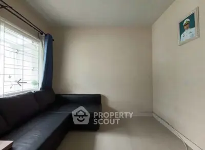 Cozy living room with corner sofa and large window for natural light.