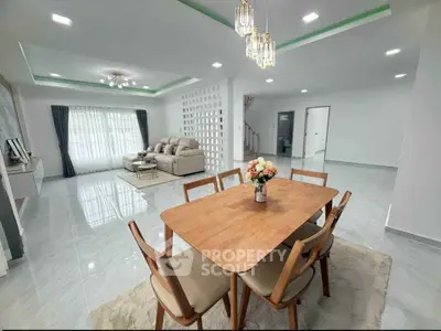 Spacious modern living and dining area with elegant decor and ample natural light.