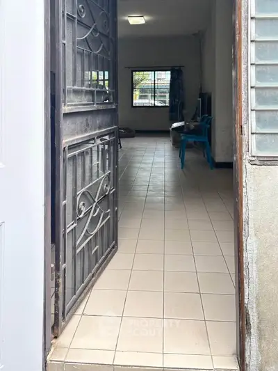 Inviting entrance to a cozy living space with tiled flooring and natural light.