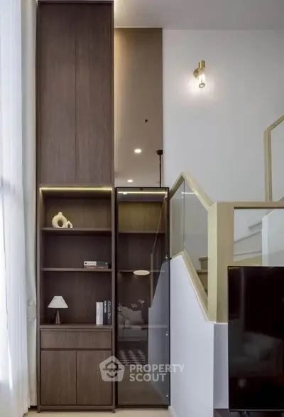 Modern interior with stylish wooden shelving and elegant staircase design.