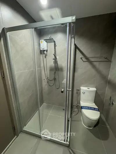 Modern bathroom with sleek shower enclosure and contemporary fixtures.