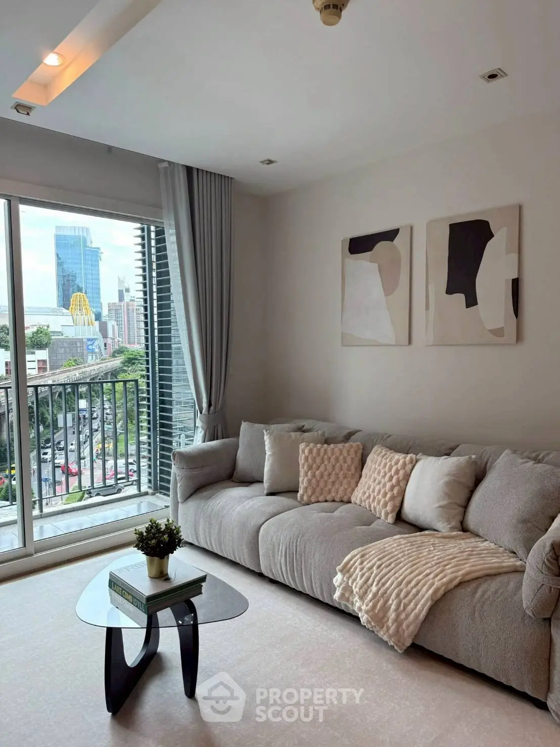 Modern living room with cozy sofa and city view balcony