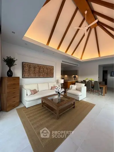 Luxurious living room with high vaulted ceiling and elegant wooden accents, perfect for modern living.