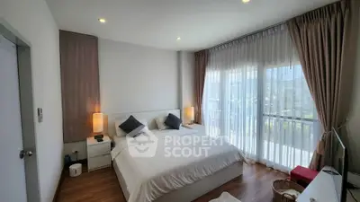 Spacious and bright bedroom with modern decor and large windows offering natural light.