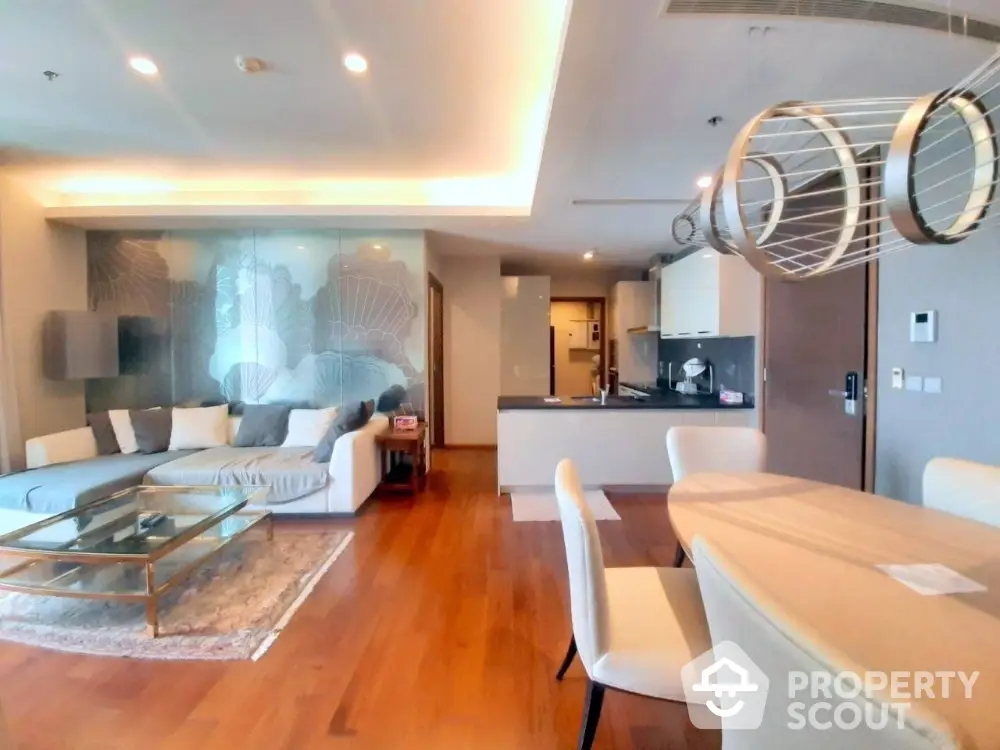 Luxurious open-layout living room with modern kitchen and elegant dining area.