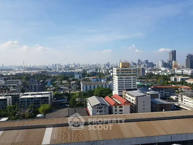 Stunning cityscape view from high-rise building showcasing urban skyline and clear blue sky.