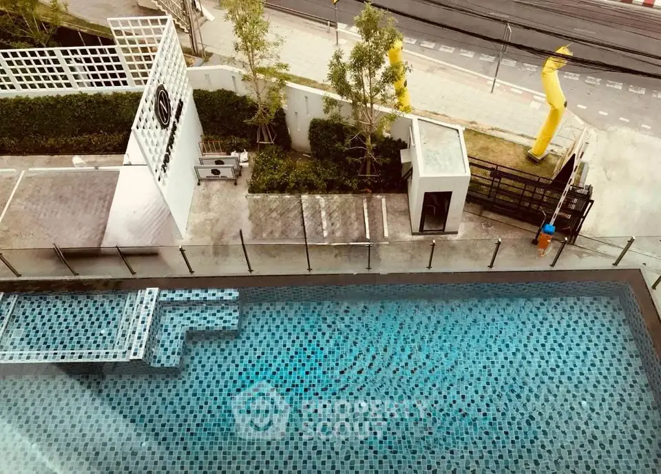 Stunning aerial view of modern swimming pool with stylish design and urban surroundings.