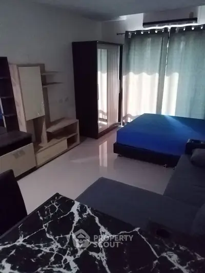 Cozy studio apartment with modern furnishings and natural light