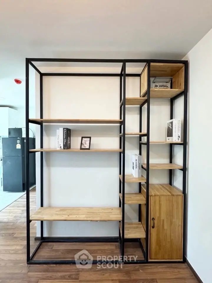 Modern wooden shelving unit with metal frame in stylish interior space.