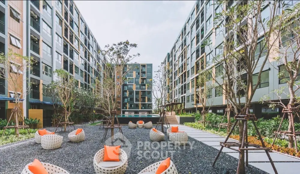 Modern apartment complex with stylish outdoor seating and lush landscaping