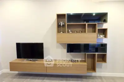 Modern living room with stylish wooden wall-mounted shelves and flat-screen TV.