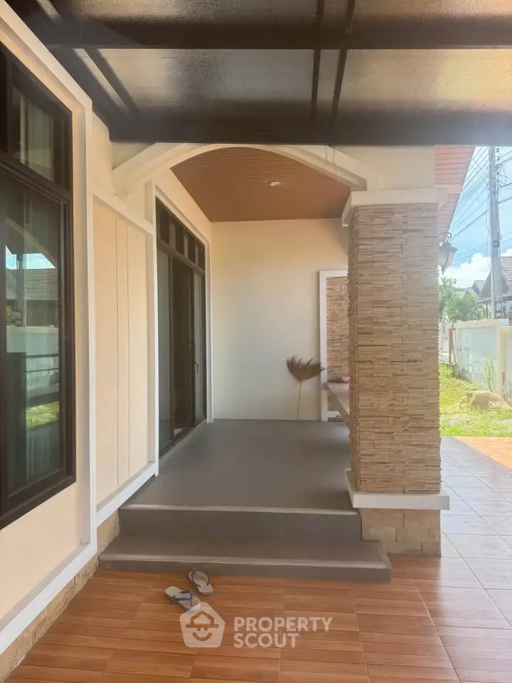 Charming house entrance with modern design and cozy porch area, perfect for welcoming guests.