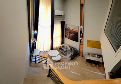 Modern loft-style living room with high ceilings and large windows