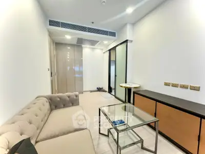 Modern living room with elegant sofa and glass coffee table in a stylish apartment.