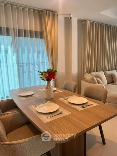 Elegant dining area with modern table and chairs, featuring stylish decor and natural light.