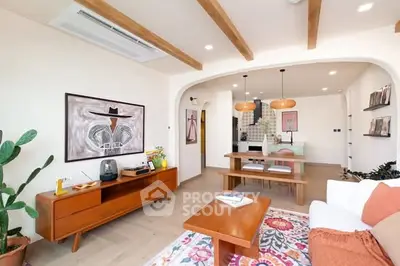 Charming open-plan living room with modern decor and wooden accents