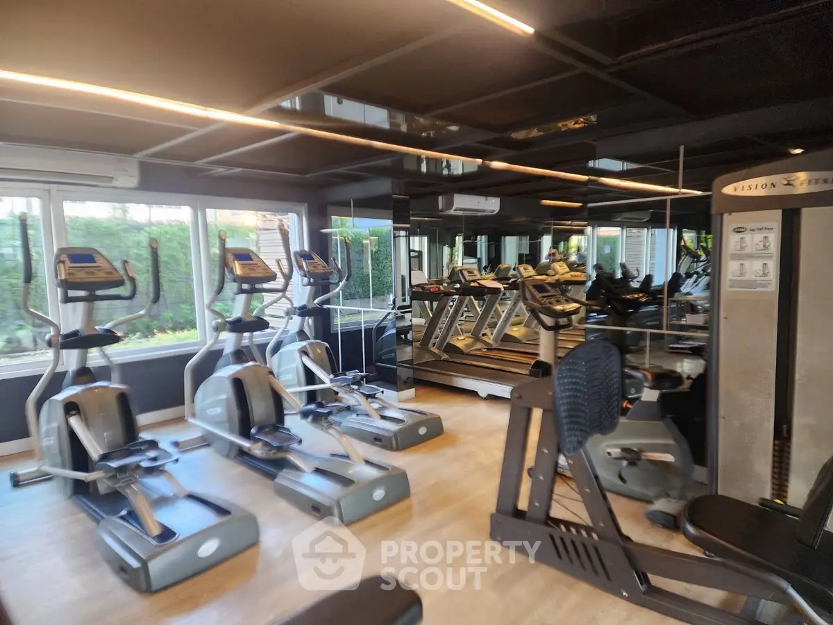 Modern gym with state-of-the-art fitness equipment and mirrored walls