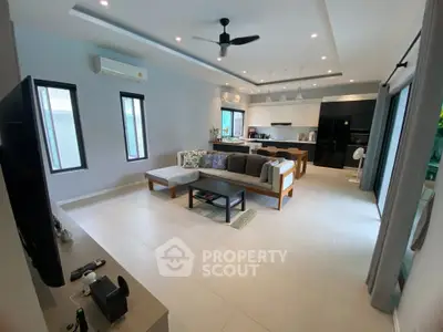 Spacious modern living room with open kitchen and stylish decor