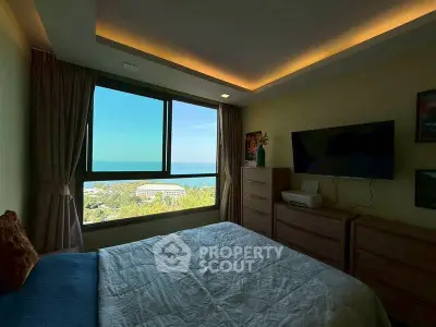 Cozy bedroom with ocean view and modern furnishings