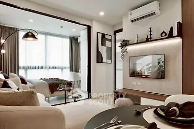 Modern living room with open layout and stylish decor, featuring a cozy bedroom view.