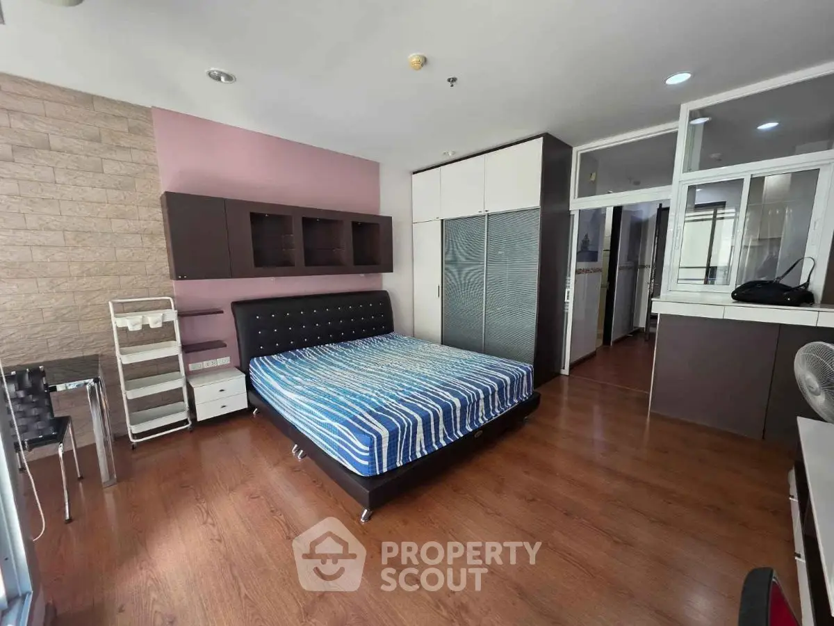 Spacious modern bedroom with stylish decor and ample storage space