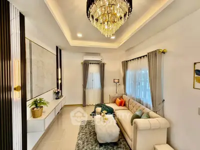 Luxurious living room with elegant chandelier and plush sofa in modern home