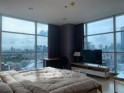 Luxurious bedroom with panoramic city view and modern furnishings