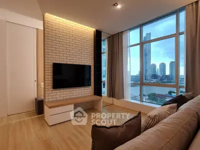 Modern living room with large windows offering stunning cityscape views, featuring sleek furniture and a mounted TV.