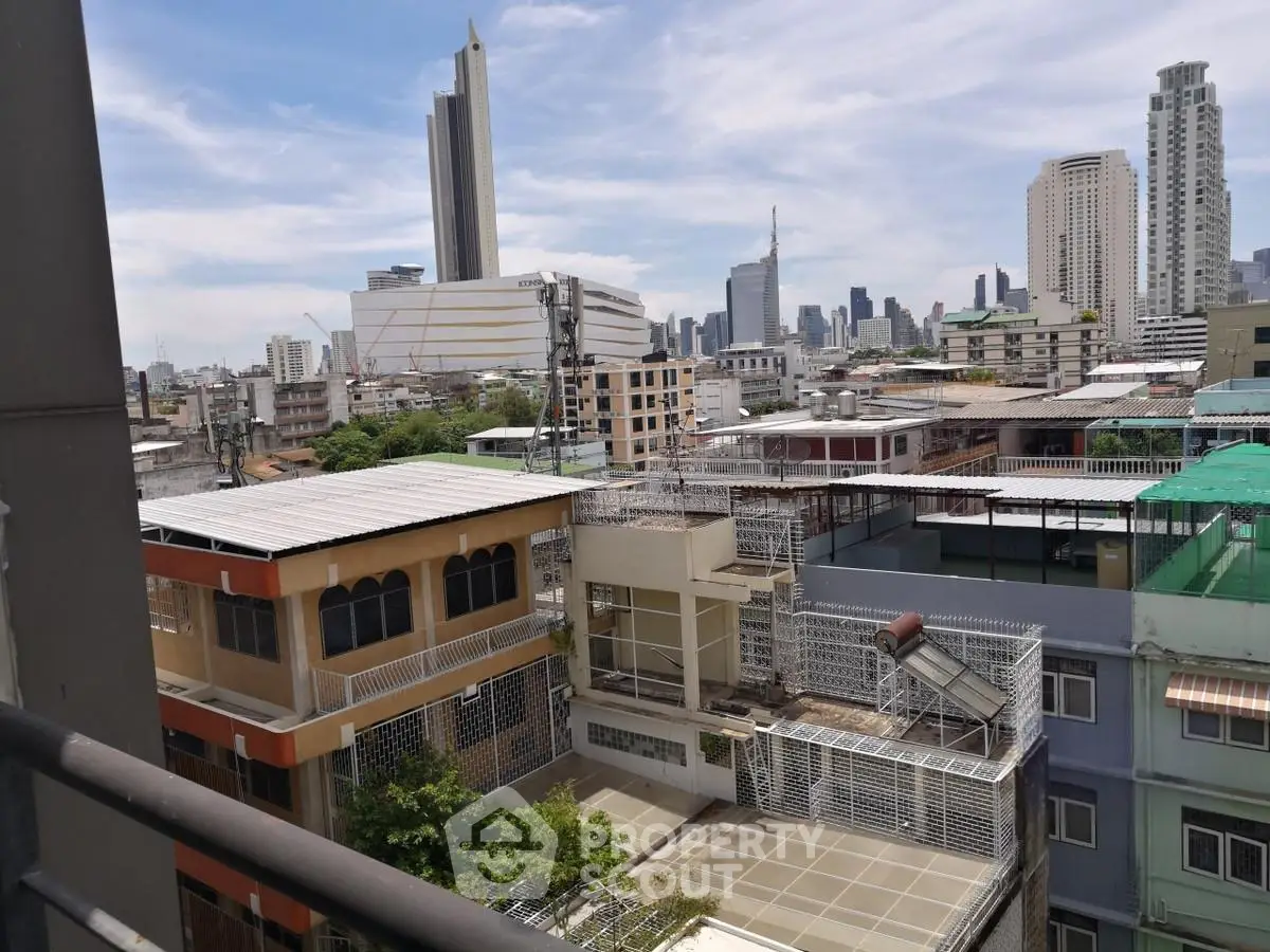 Stunning cityscape view from a high-rise balcony showcasing urban skyline and modern architecture.