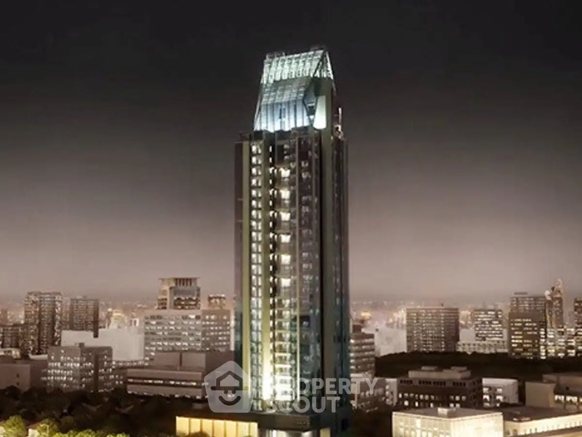 Stunning night view of a modern skyscraper in a vibrant cityscape, showcasing architectural elegance.