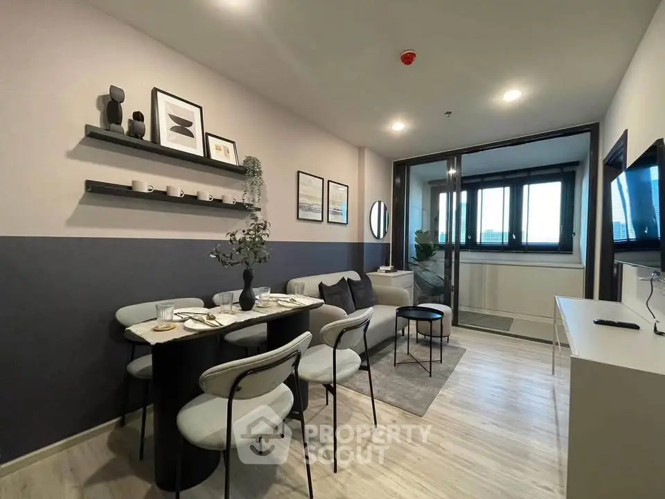 Modern living room with dining area and stylish decor in a contemporary apartment.