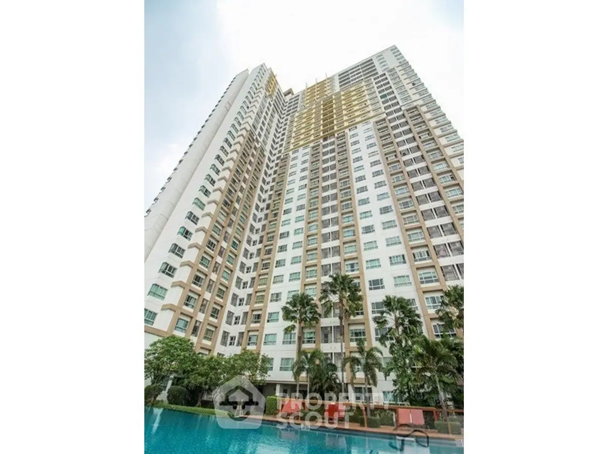 Stunning high-rise building with poolside view and lush greenery, perfect for urban living.
