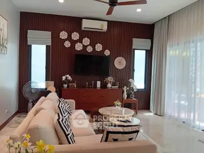 Stylish living room with modern decor, large windows, and cozy seating area.