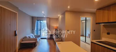Modern apartment interior with open layout, cozy living area, and balcony view.