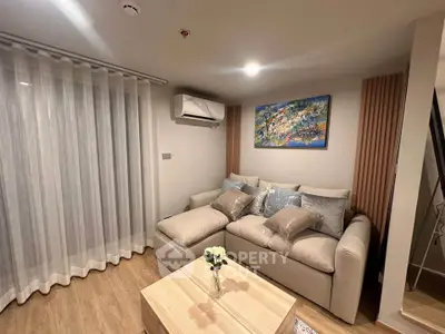 Cozy living room with modern decor and comfortable seating in a stylish apartment.