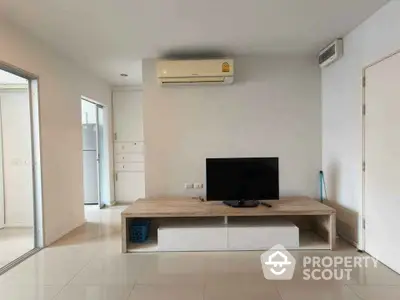 Modern living room with minimalist decor and air conditioning unit