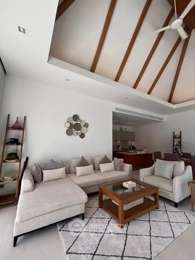 Luxurious living room with high ceiling and modern decor in a stylish home.