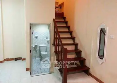 Unique small space with staircase and compact bathroom, ideal for creative interior design solutions.