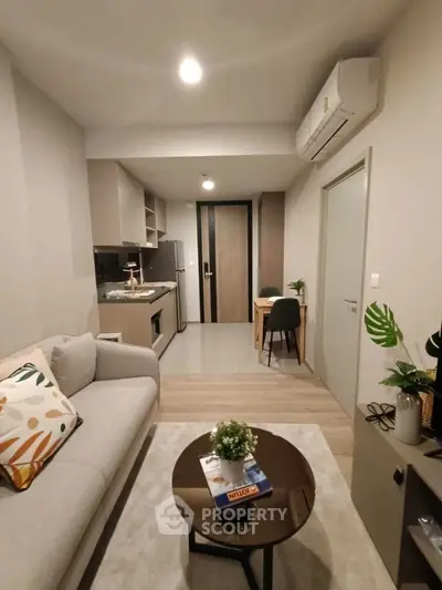 Modern living room with open kitchen layout and stylish decor