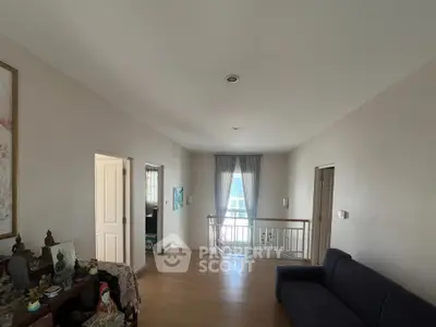 Spacious upstairs hallway with natural light and wooden flooring