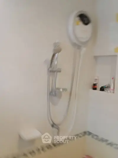 Modern bathroom with shower and water heater, ideal for comfortable living.