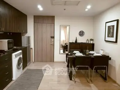 Modern kitchen with dining area featuring sleek appliances and stylish decor