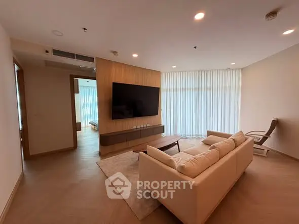Spacious modern living room with large TV and elegant decor