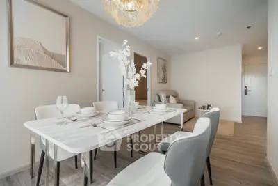 Modern dining area with elegant table setting and cozy living space in a stylish apartment.