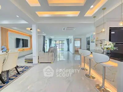 Luxurious open-plan living room with modern kitchen and elegant decor