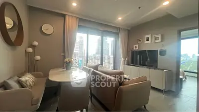 Modern living room with city view, stylish furniture, and large windows.