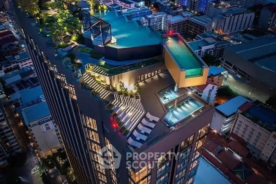 Stunning rooftop pool and terrace with panoramic city views in luxury high-rise building.