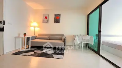 Modern living room with stylish decor and sliding glass doors to bedroom