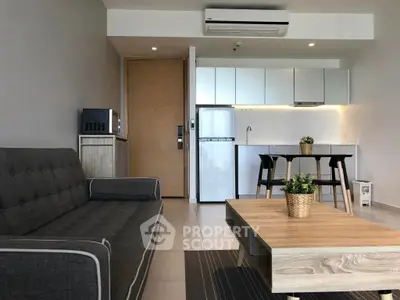 Modern living room with sleek kitchen, stylish furniture, and contemporary design in open layout apartment.