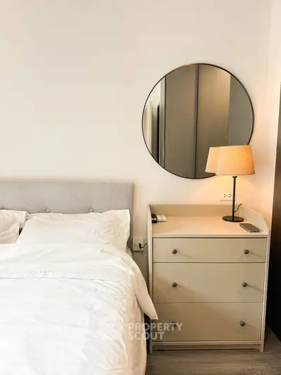 Cozy bedroom with modern decor and stylish round mirror